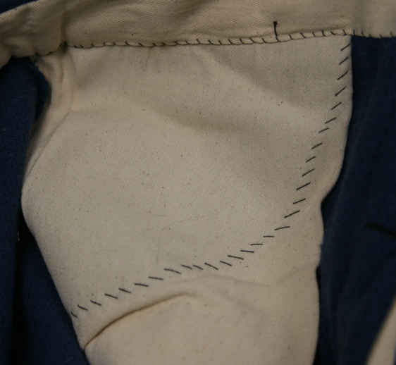 Hand stitching of pocket bag.